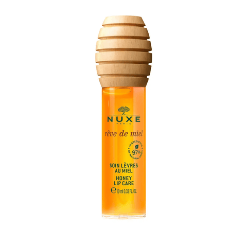 Lip balm tube with honey-colored liquid and wooden top.