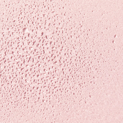 Pink textured surface with tiny holes.