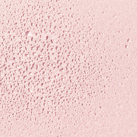 Pink textured surface with tiny holes.