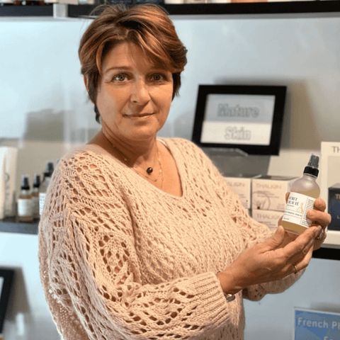 Woman holding spray bottle, Nature Skin product