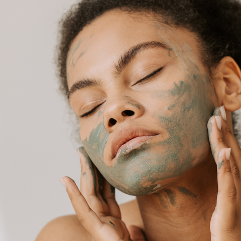 Woman applying face mask