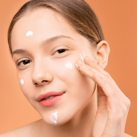Woman applying facial cream