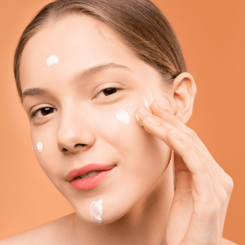 Woman applying facial cream
