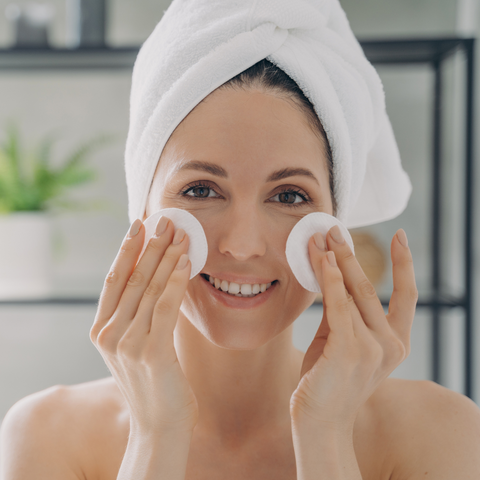 Woman using cotton pads for skincare