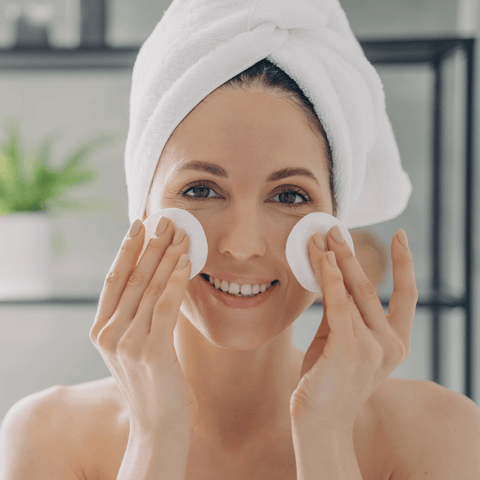 Woman using cotton pads for skincare