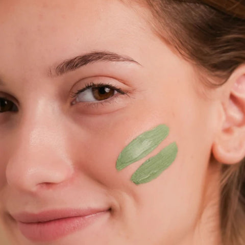 women with Cattier green clay mask on her face