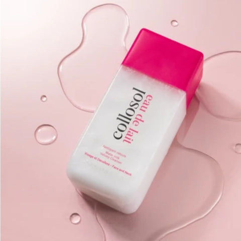 A bottle of Collosol Eau de Lait face and neck cleanser, featuring a white bottle with a vibrant pink cap, set against a pink background with decorative liquid swirls and water droplets.