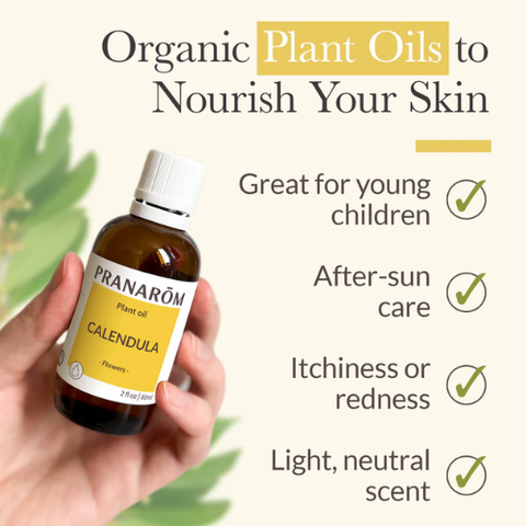 Hand holding a bottle of Pranarom Calendula plant oil with text about its benefits.